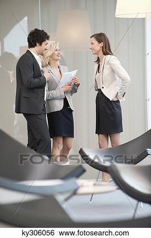 Business executives discussing in an office View Large Photo Image Stock Photograph - Business executives discussing in an office. Fotosearch