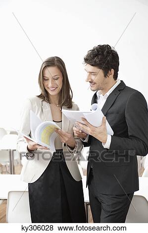 Business executives looking at documents View Large Photo Image Stock Photo - Business executives looking at documents. Fotosearch