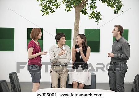 Business executives talking to each other in a conference room during a coffee break View Large Photo Image Stock Image - Business executives talking to each other in a conference room during a coffee break. Fotosearch