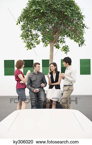 Business executives talking to each other in a conference room during a coffee break View Large Photo Image Stock Image - Business executives talking to each other in a conference room during a coffee break. Fotosearch