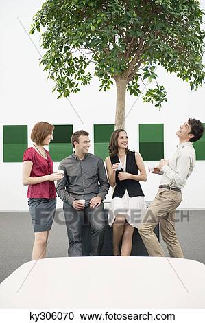 Business executives talking to each other in a conference room during a coffee break View Large Photo Image Stock Image - Business executives talking to each other in a conference room during a coffee break. Fotosearch