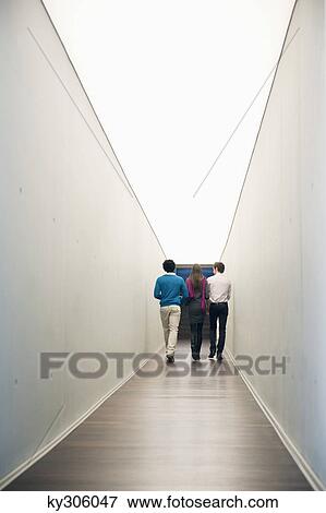 Business executives walking in the corridor of an office View Large Photo Image Stock Photo - Business executives walking in the corridor of an office. Fotosearch