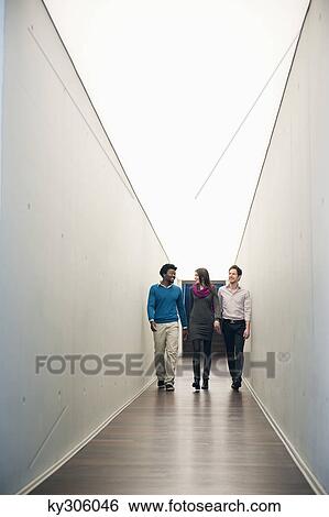 Business executives walking in the corridor of an office View Large Photo Image Stock Photograph - Business executives walking in the corridor of an office. Fotosearch