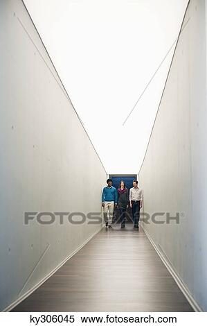 Business executives walking in the corridor of an office View Large Photo Image Stock Photography - Business executives walking in the corridor of an office. Fotosearch