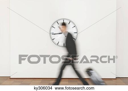 Businessman carrying his luggage View Large Photo Image Picture - Businessman carrying his luggage. Fotosearch