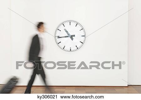 Stock Image - Businessman carrying his luggage. Fotosearch
