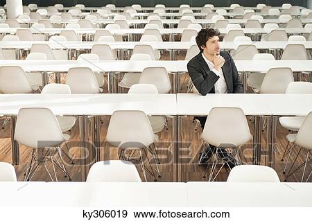 Businessman sitting at a cafeteria and thinking View Large Photo Image Stock Photo - Businessman sitting at a cafeteria and thinking. Fotosearch