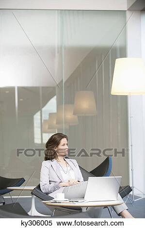 Businesswoman waiting in an office View Large Photo Image Stock Photography - Businesswoman waiting in an office. Fotosearch