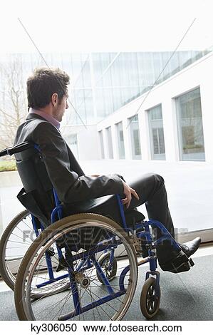 Disabled businessman sitting in a wheelchair View Large Photo Image Stock Image - Disabled businessman sitting in a wheelchair. Fotosearch