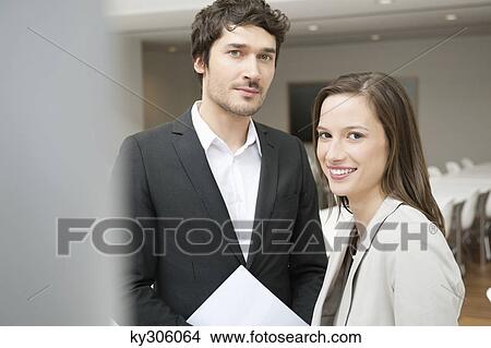 Portrait of a businesswoman smiling with her colleague beside her View Large Photo Image Picture - Portrait of a businesswoman smiling with her colleague beside her. Fotosearch
