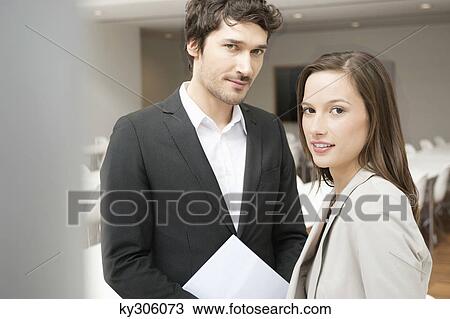Portrait of a businesswoman smiling with her colleague beside her View Large Photo Image Stock Image - Portrait of a businesswoman smiling with her colleague beside her. Fotosearch