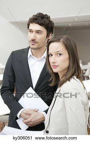 Stock Image - Portrait of a businesswoman standing with her colleague. Fotosearch