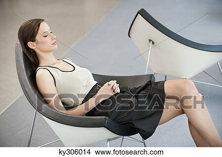 Woman reclining in a chair and thinking View Large Photo Image Picture - Woman reclining in a chair and thinking. Fotosearch