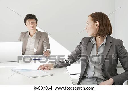 Business executives discussing in a conference room View Large Photo Image Picture - Business executives discussing in a conference room. Fotosearch