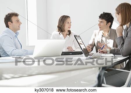 Business executives discussing in a meeting View Large Photo Image Stock Photo - Business executives discussing in a meeting. Fotosearch