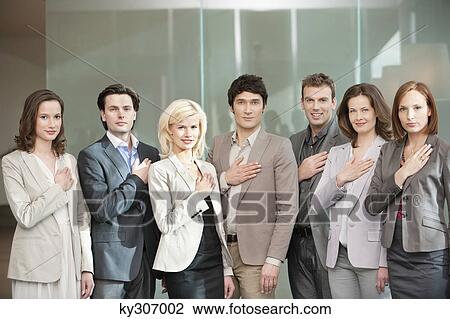 Stock Image - Business executives with their hands on their chest. Fotosearch
