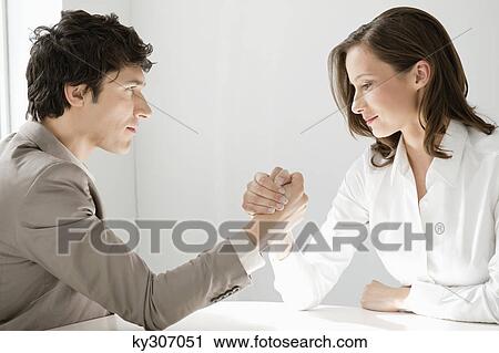 Businessman arm wrestling with a businesswoman View Large Photo Image Stock Image - Businessman arm wrestling with a businesswoman. Fotosearch