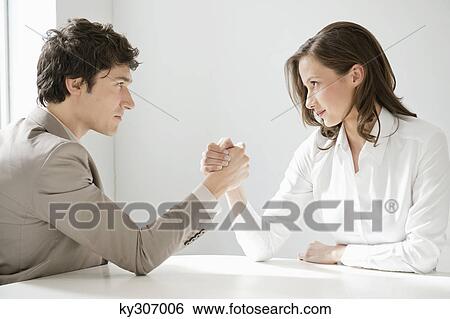 Businessman arm wrestling with a businesswoman View Large Photo Image Stock Photograph - Businessman arm wrestling with a businesswoman. Fotosearch
