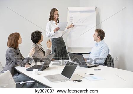 Businesswoman giving presentation in a meeting View Large Photo Image Stock Photo - Businesswoman giving presentation in a meeting. Fotosearch