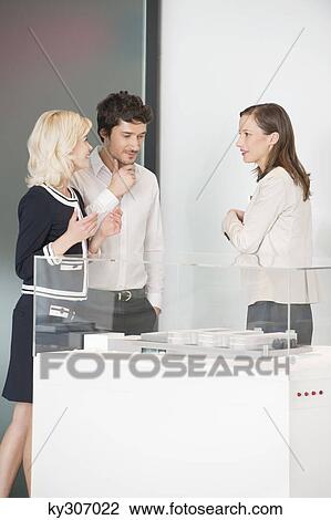Man with two women looking at an architectural model View Large Photo Image Stock Image - Man with two women looking at an architectural model. Fotosearch