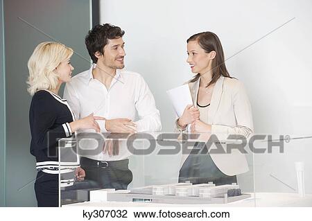 Man with two women near an architectural model View Large Photo Image Stock Image - Man with two women near an architectural model. Fotosearch