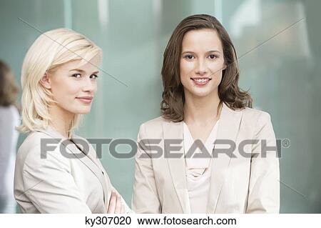 Portrait of two businesswomen smiling together View Large Photo Image Stock Image - Portrait of two businesswomen smiling together. Fotosearch