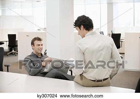 Two businessmen working in an office View Large Photo Image Picture - Two businessmen working in an office. Fotosearch