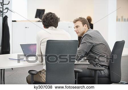 Two businessmen working in an office View Large Photo Image Stock Photo - Two businessmen working in an office. Fotosearch