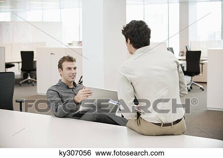 Two businessmen working in an office View Large Photo Image Stock Photograph - Two businessmen working in an office. Fotosearch