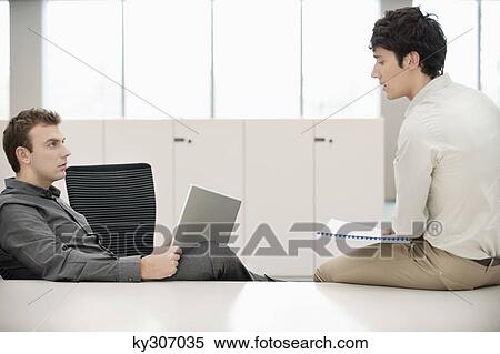Two businessmen working in an office View Large Photo Image Stock Photography - Two businessmen working in an office. Fotosearch