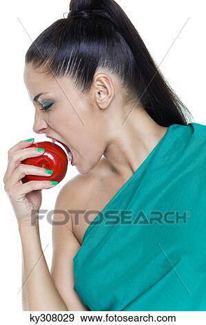 Young woman biting an apple View Large Photo Image Stock Photo - Young woman biting an apple. Fotosearch
