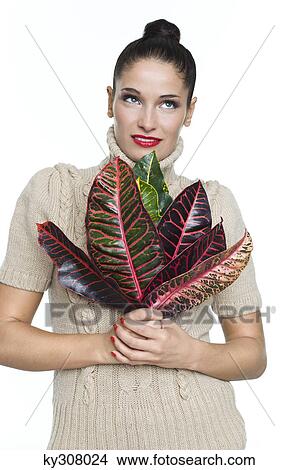 Young woman holding leaves View Large Photo Image Picture - Young woman holding leaves. Fotosearch
