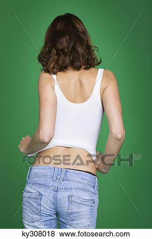 Young woman in tank top and jeans, rear view View Large Photo Image Stock Photo - Young woman in tank top and jeans, rear view. Fotosearch