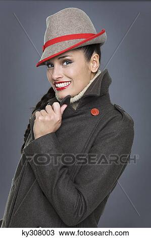 Young woman wearing jacket and fedora View Large Photo Image Stock Image - Young woman wearing jacket and fedora. Fotosearch