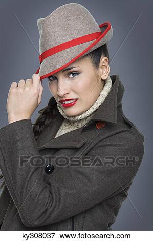 Young woman wearing jacket and fedora View Large Photo Image Stock Photo - Young woman wearing jacket and fedora. Fotosearch