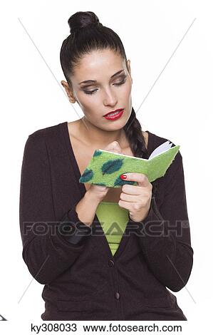 Young woman writing in notebook View Large Photo Image Stock Image - Young woman writing in notebook. Fotosearch