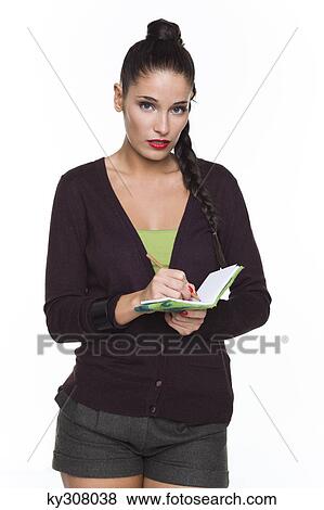 Stock Photo - Young woman writing in notebook. Fotosearch