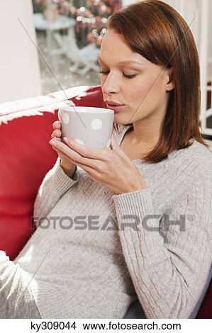 Young woman drinking coffee View Large Photo Image Picture - Young woman drinking coffee. Fotosearch