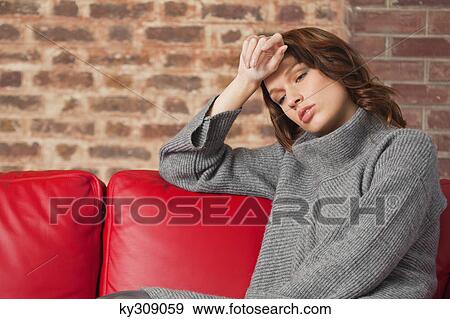 Young woman looking tired View Large Photo Image Stock Photo - Young woman looking tired. Fotosearch