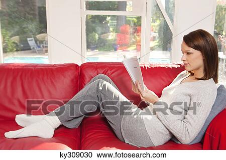 Young woman reading a book View Large Photo Image Stock Image - Young woman reading a book. Fotosearch