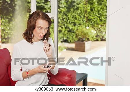 Young woman using iPhone View Large Photo Image Stock Image - Young woman using iPhone. Fotosearch