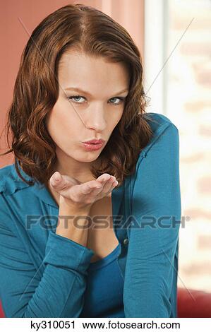 Young woman blowing a kiss View Large Photo Image Stock Image - Young woman blowing a kiss. Fotosearch