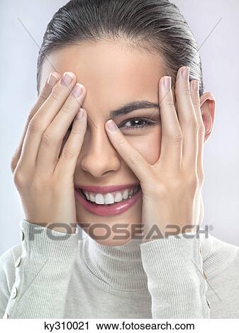 Young woman covering face with hands View Large Photo Image Stock Image - Young woman covering face with hands. Fotosearch