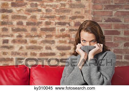 Young woman hiding her face with sweater View Large Photo Image Stock Photography - Young woman hiding her face with sweater. Fotosearch