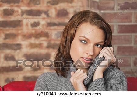 Stock Image - Young woman looking at camera. Fotosearch