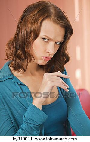 Stock Image - Young woman pouting. Fotosearch