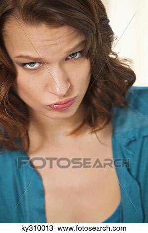 Stock Image - Young woman pouting. Fotosearch