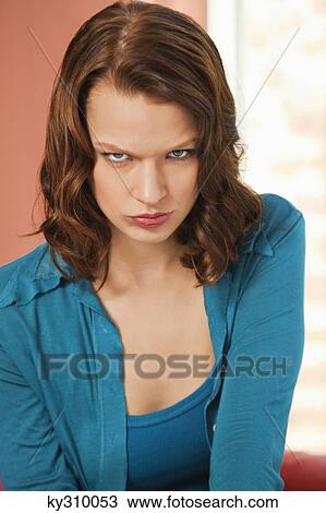 Stock Image - Young woman pouting. Fotosearch