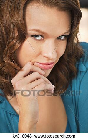 Young woman smiling at camera View Large Photo Image Stock Photo - Young woman smiling at camera. Fotosearch