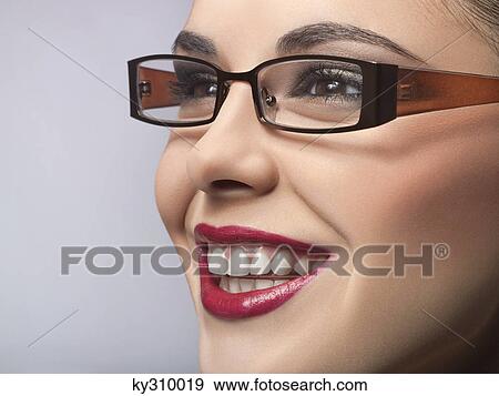 Stock Photo - Young woman wearing eyeglasses. Fotosearch